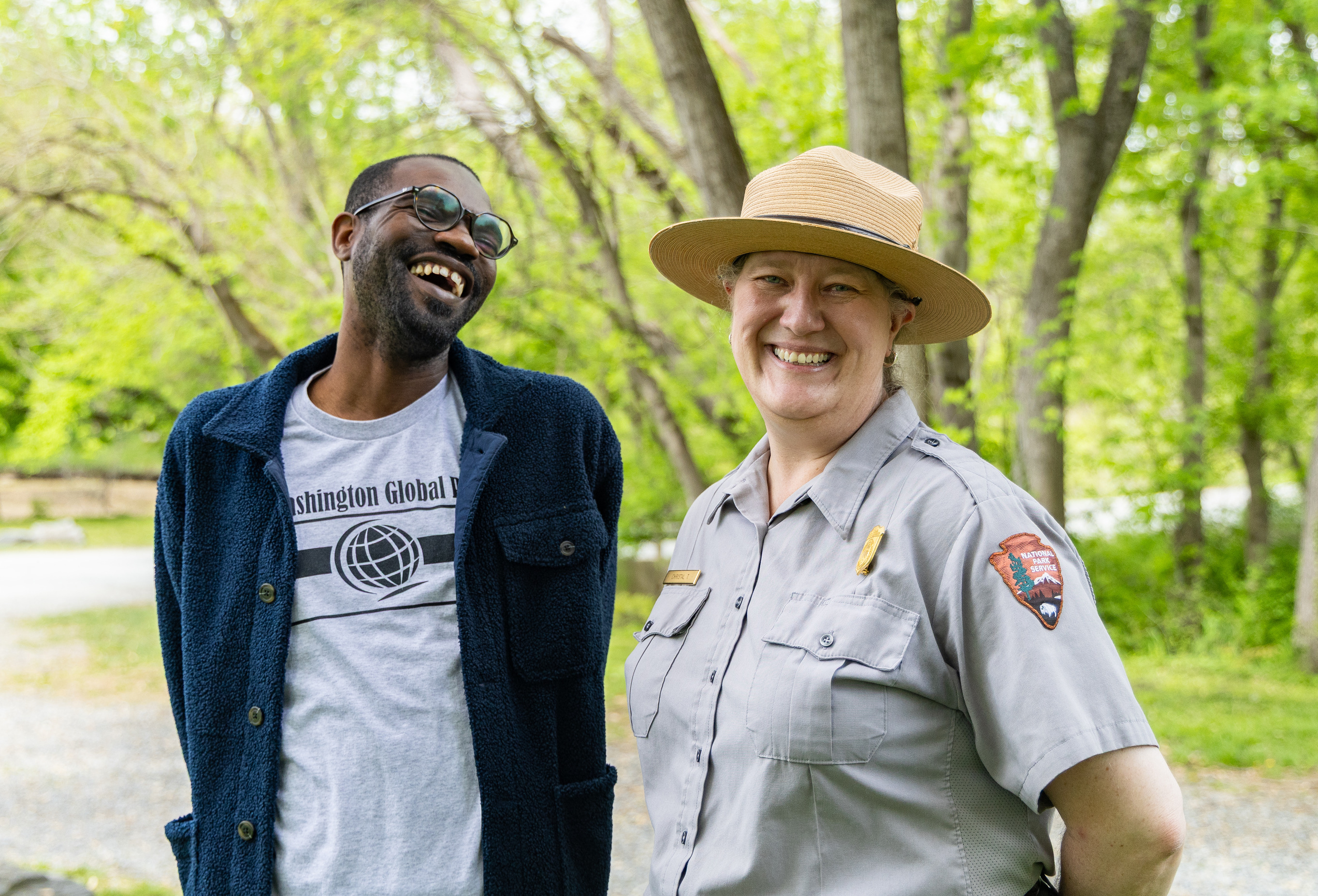 Chesapeake and Ohio Canal National Historical Park Ranger Christal Tongish and a staff member from the Washington Global Public Charter School enjoy Earth Day at Fletcher’s Cove April 22, 2025.