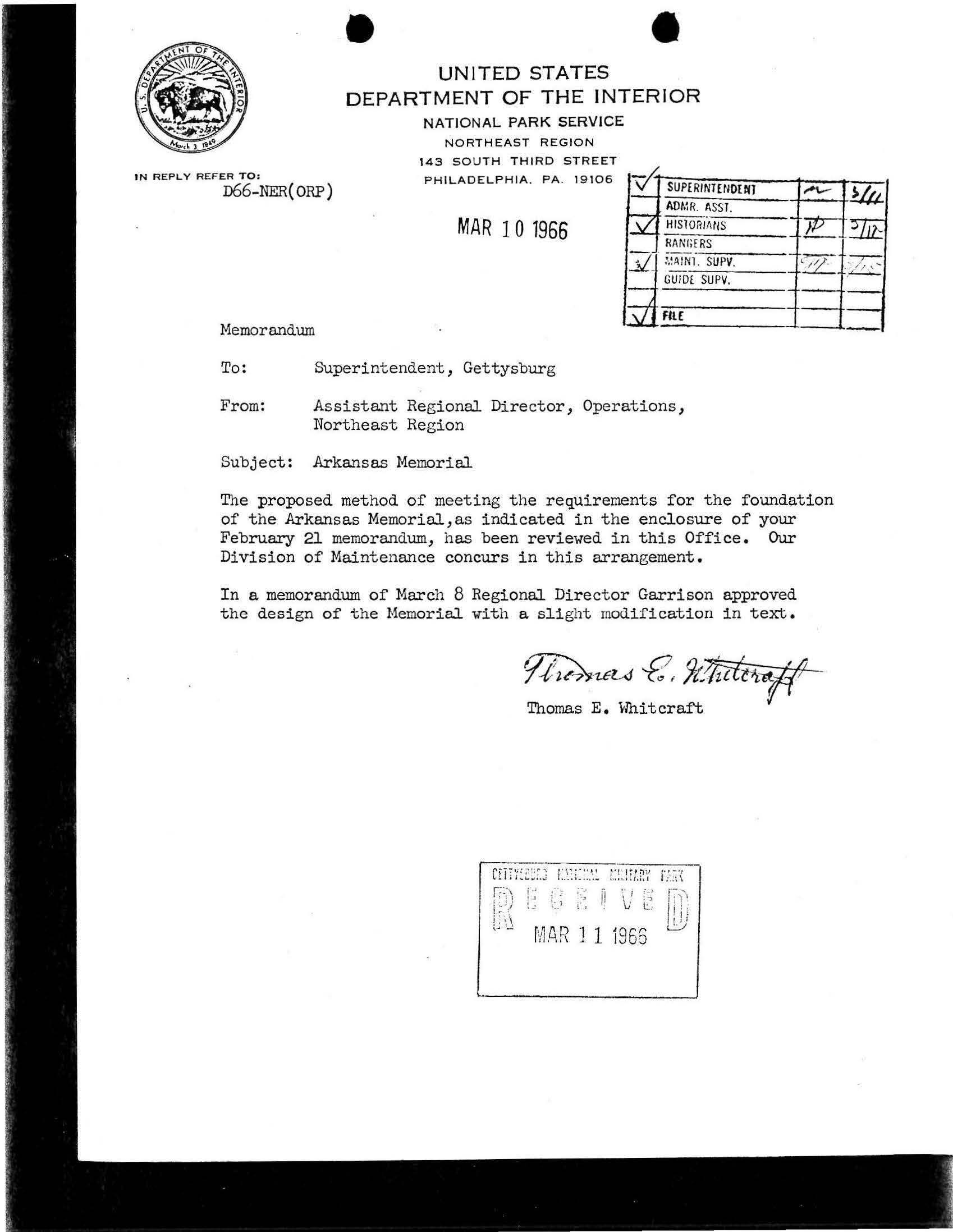 White paper with typed black text and a handwritten signature