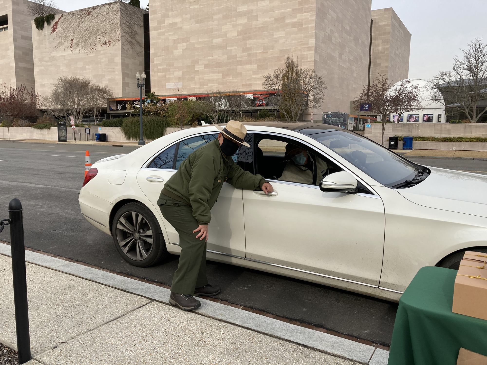  A ranger and volunteer pose at a drive-through celebration. 