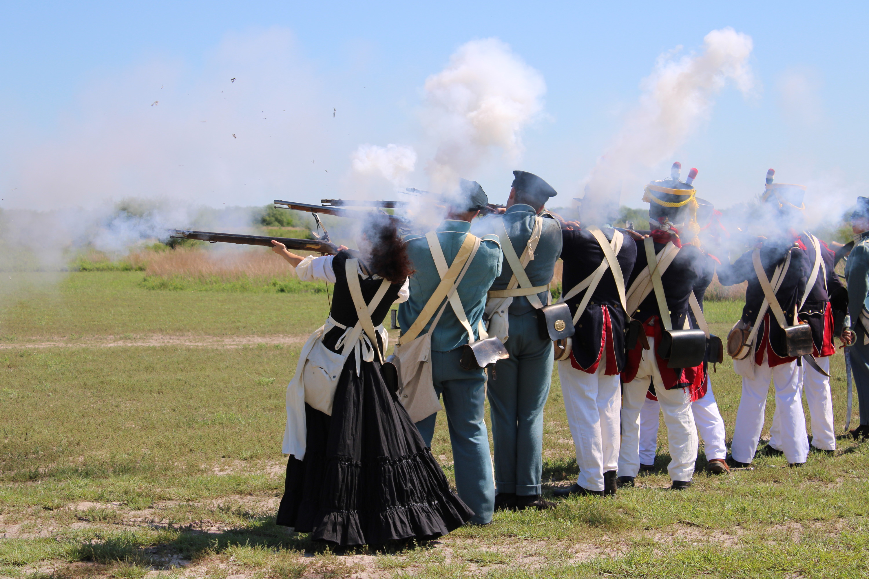 Row of volunteers fire muskets