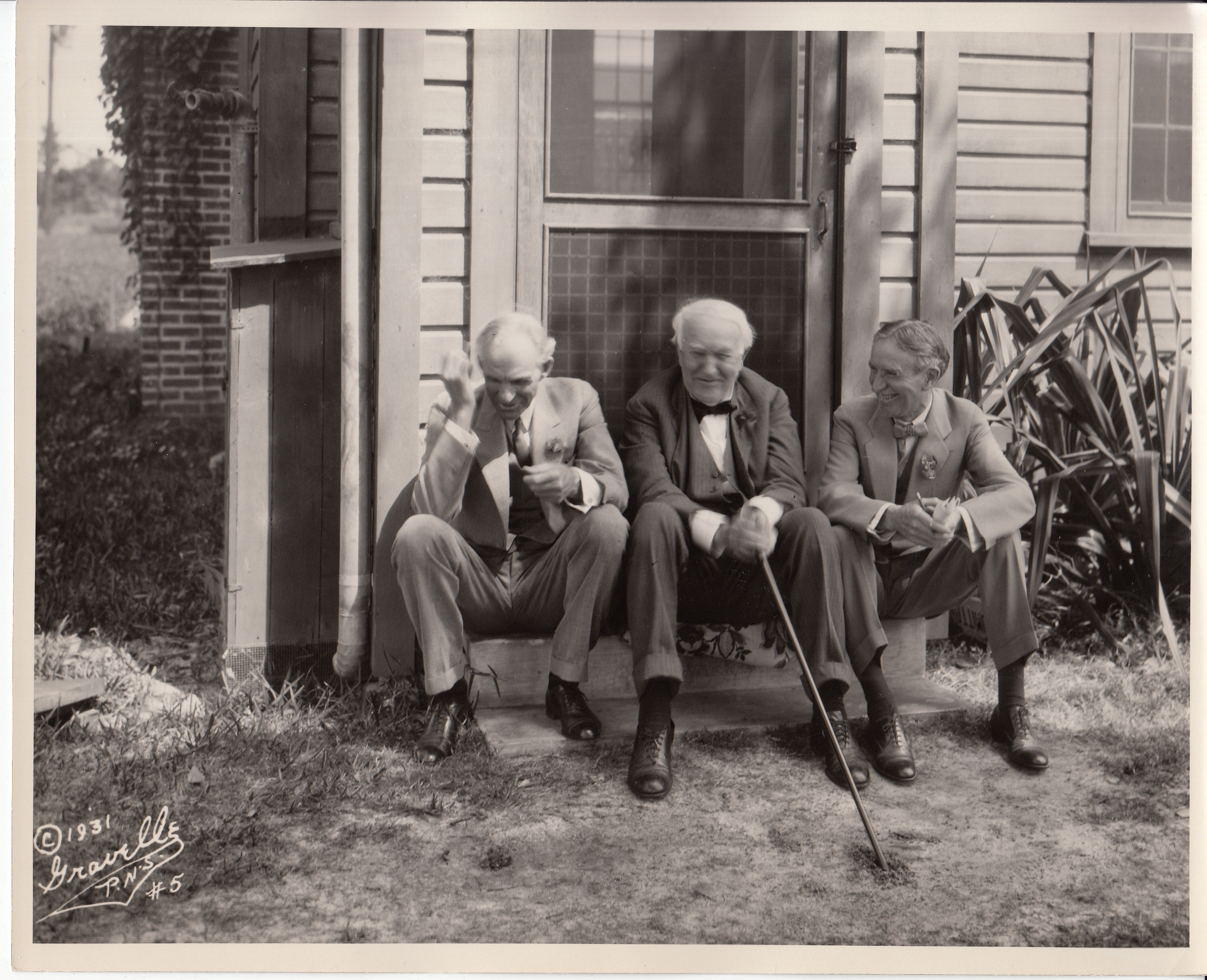 Harvey Firestone, Henry Ford, and Thomas Edison sitting on the stoop of the Fort Myers lab.