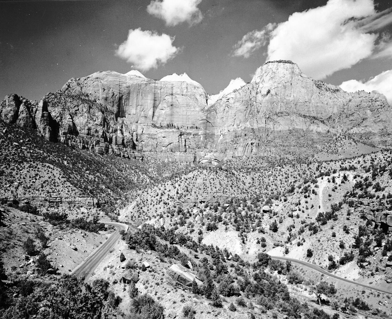 The Sentinel and the Streaked Wall from Pine Creek Canyon. Zion-Mt. Carmel Highway switchbacks in foreground.