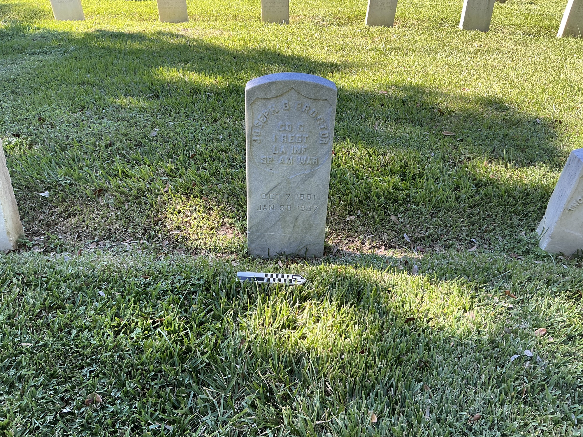 Extra image of historic upright marble headstone with recessed shield face.