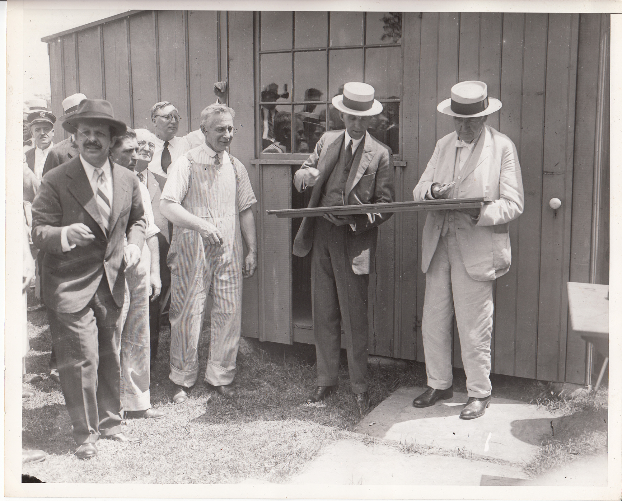 Henry Ford and Thomas Edison autographing board at presentation of Glass House.