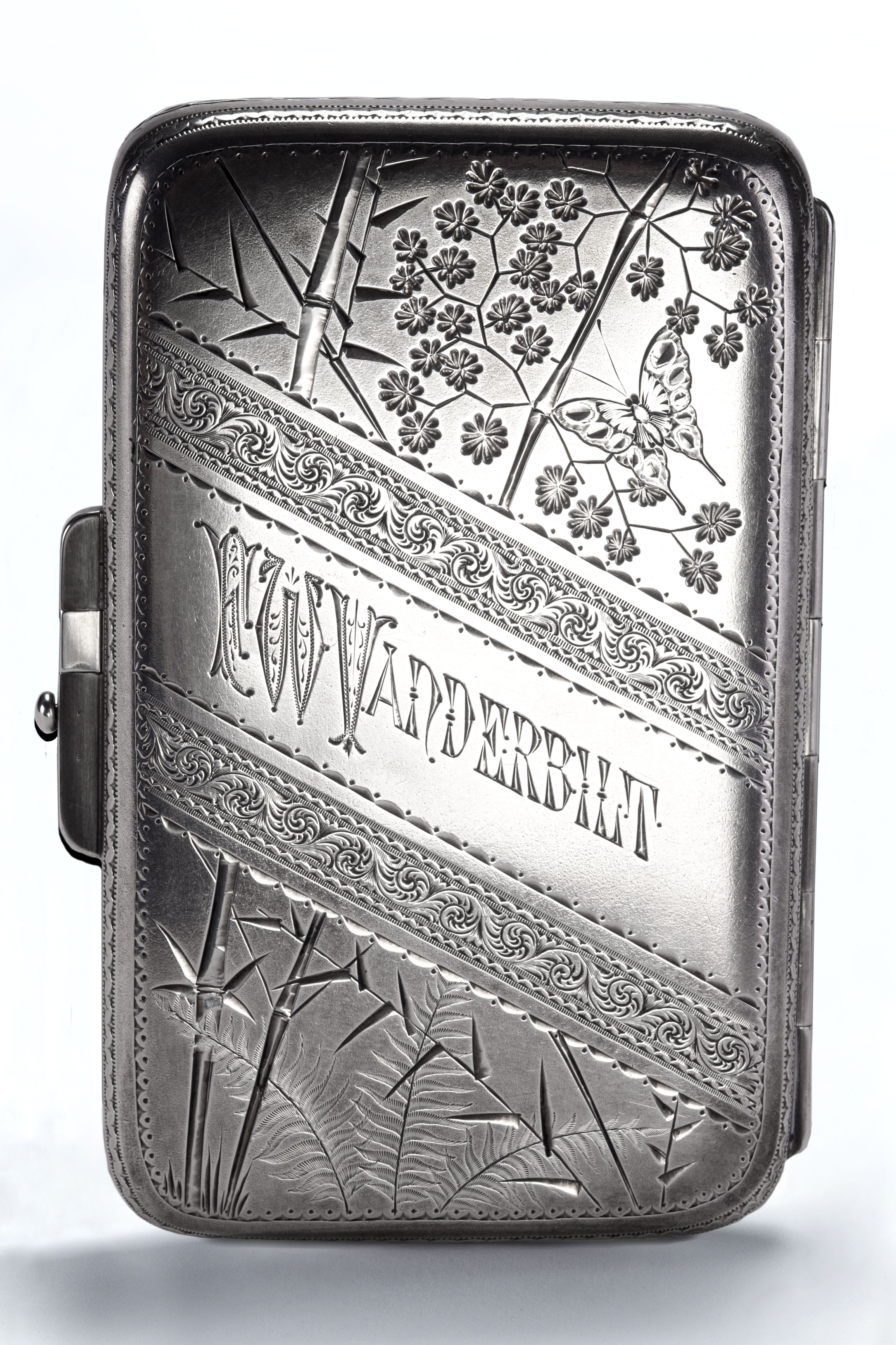 A rectangular silver cigarette case engraved in the Japonesque style with butterfly and floral and bamboo motifs, engraved "F. W. Vanderbilt."