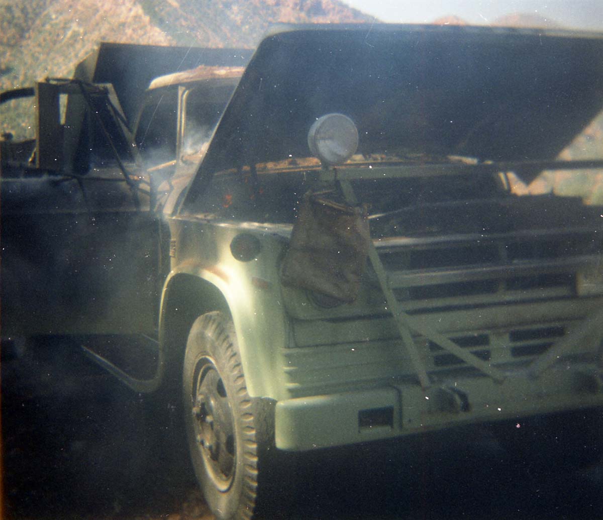 Color photo of an engine fire in a pickup.