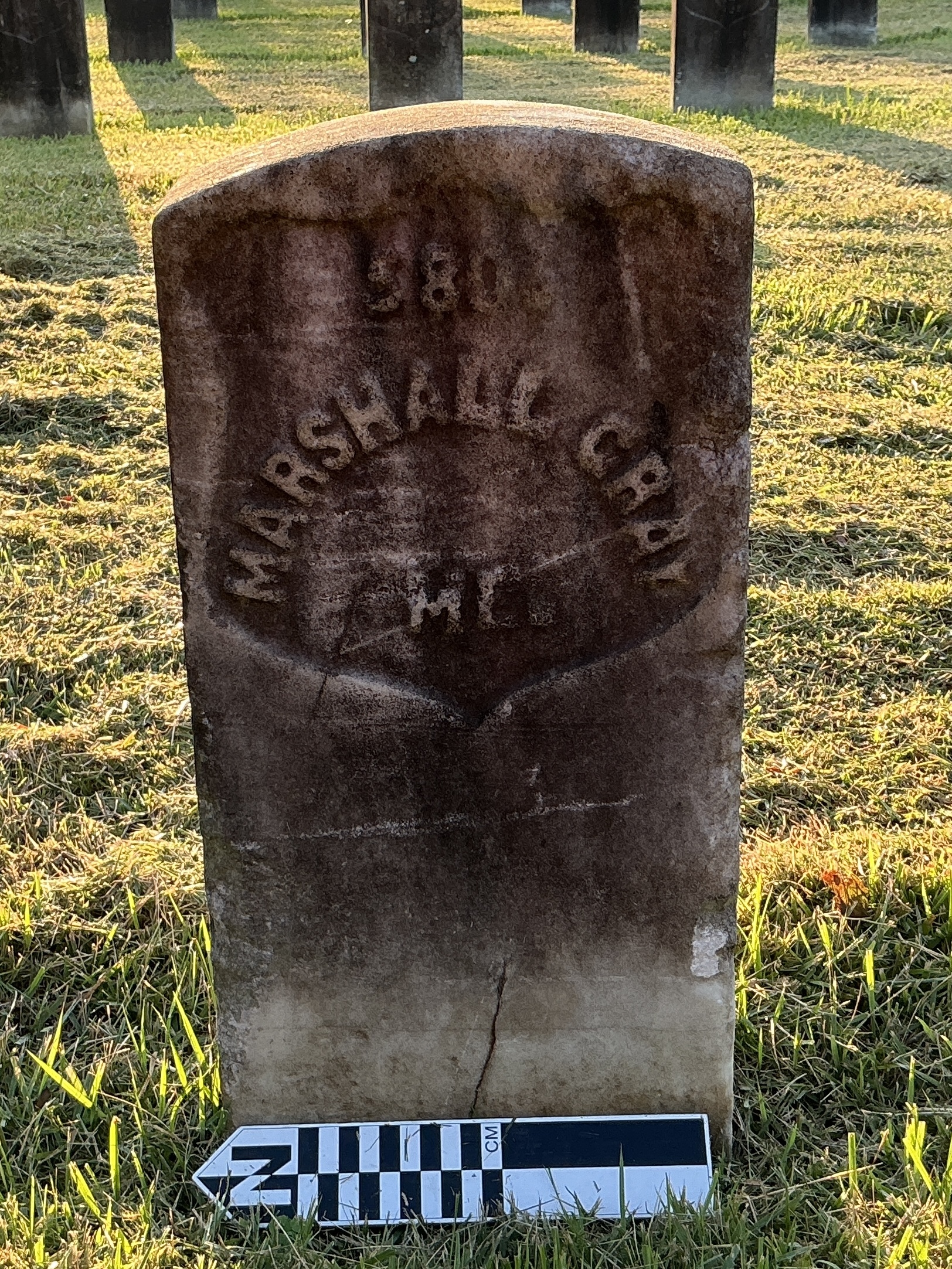 Extra image of historic upright marble headstone with recessed shield face.