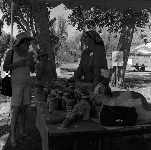 Woman talking with visitors about her demonstration on preserving foods at the first annual Folklife Festival, Zion National Park Nature Center, September 1977.