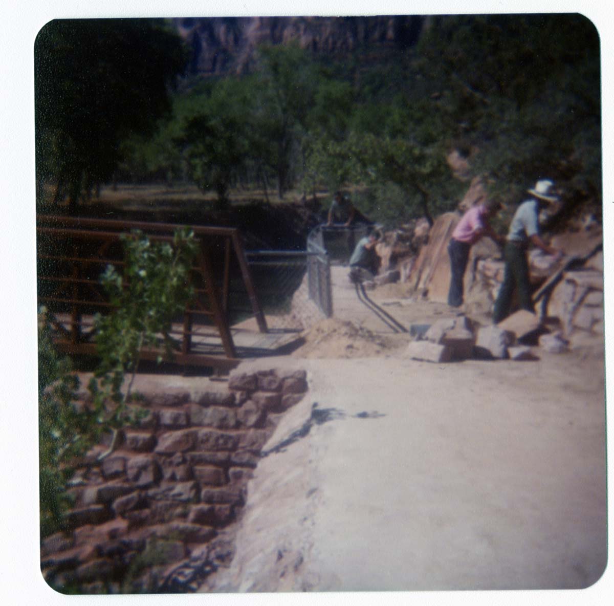 Men working on trail by the new Grotto footbridge.