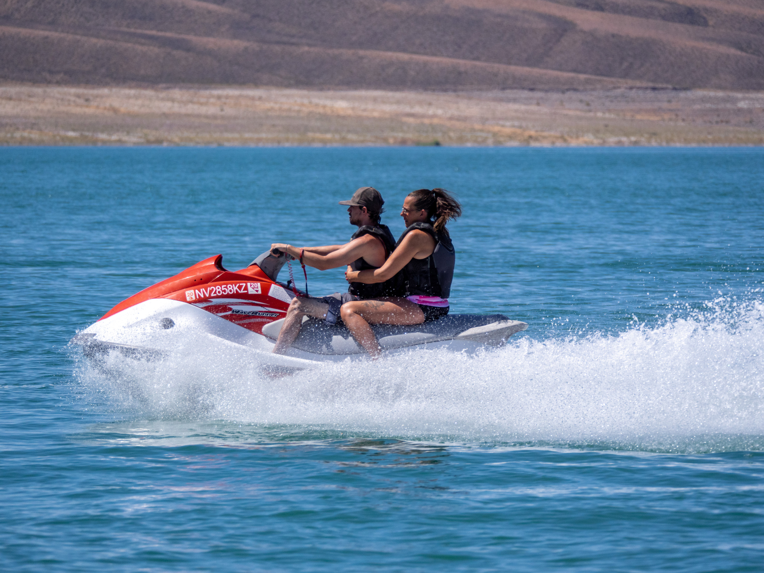 man and woman riding PWC, middle of frame