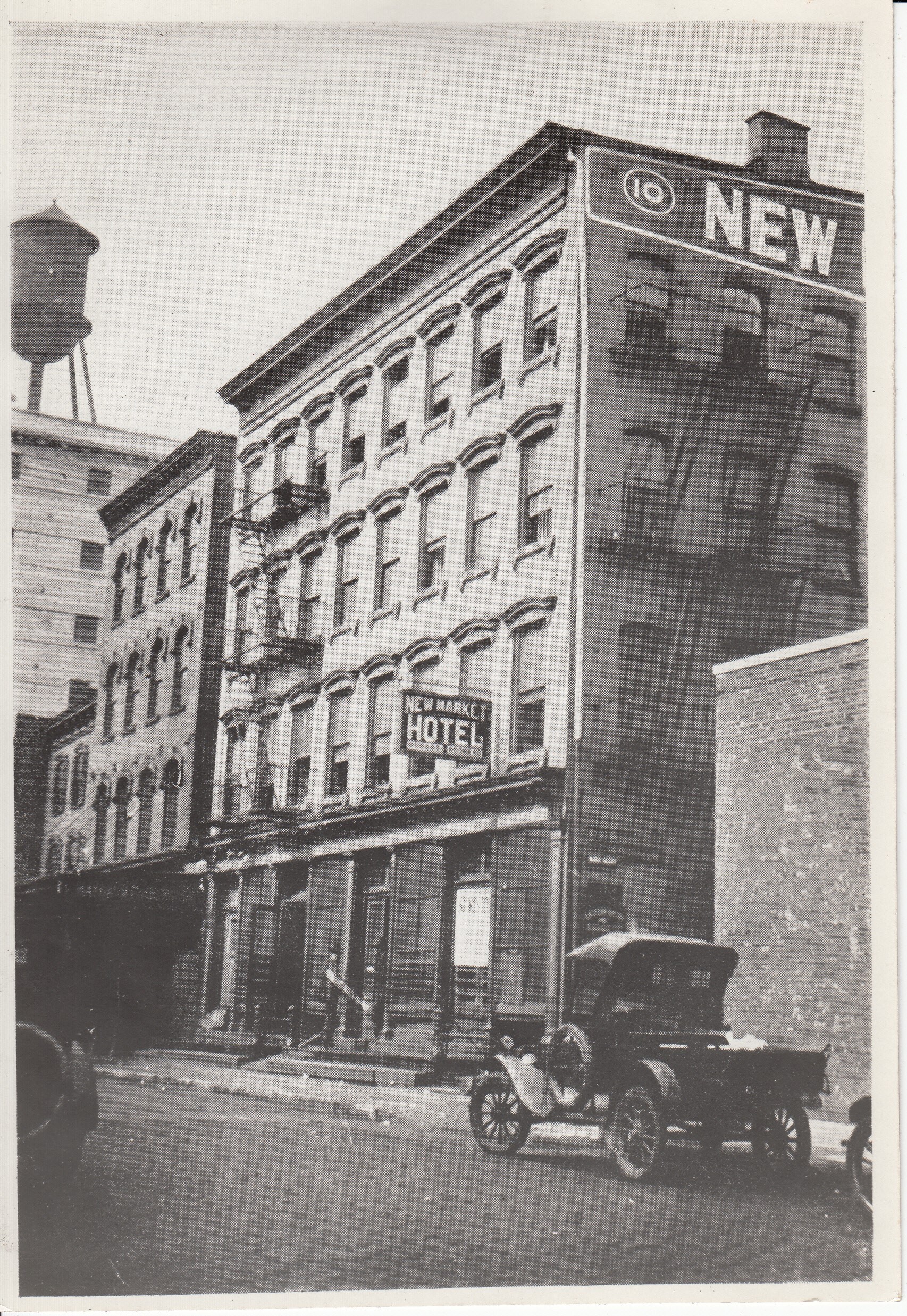 Original home of Thomas Edison's shop at 10-12 Ward St in Newark. Sign on building has text: "New Market Hotel"