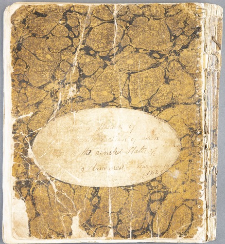 marbled paper with oval label with handwritten text
