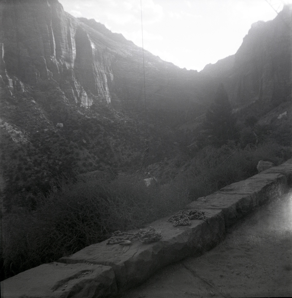 Completed rock retaining wall alongside road at the Zion-Mt. Carmel Highway tunnel, canyon in the background.
