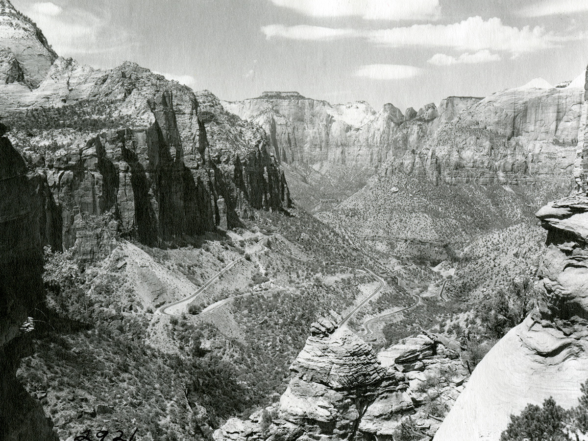View from Canyon Overlook Trail towards Zion-Mt. Carmel Highway Switchbacks, Standard oil Company photo. [Negative is colorized with reddish color]