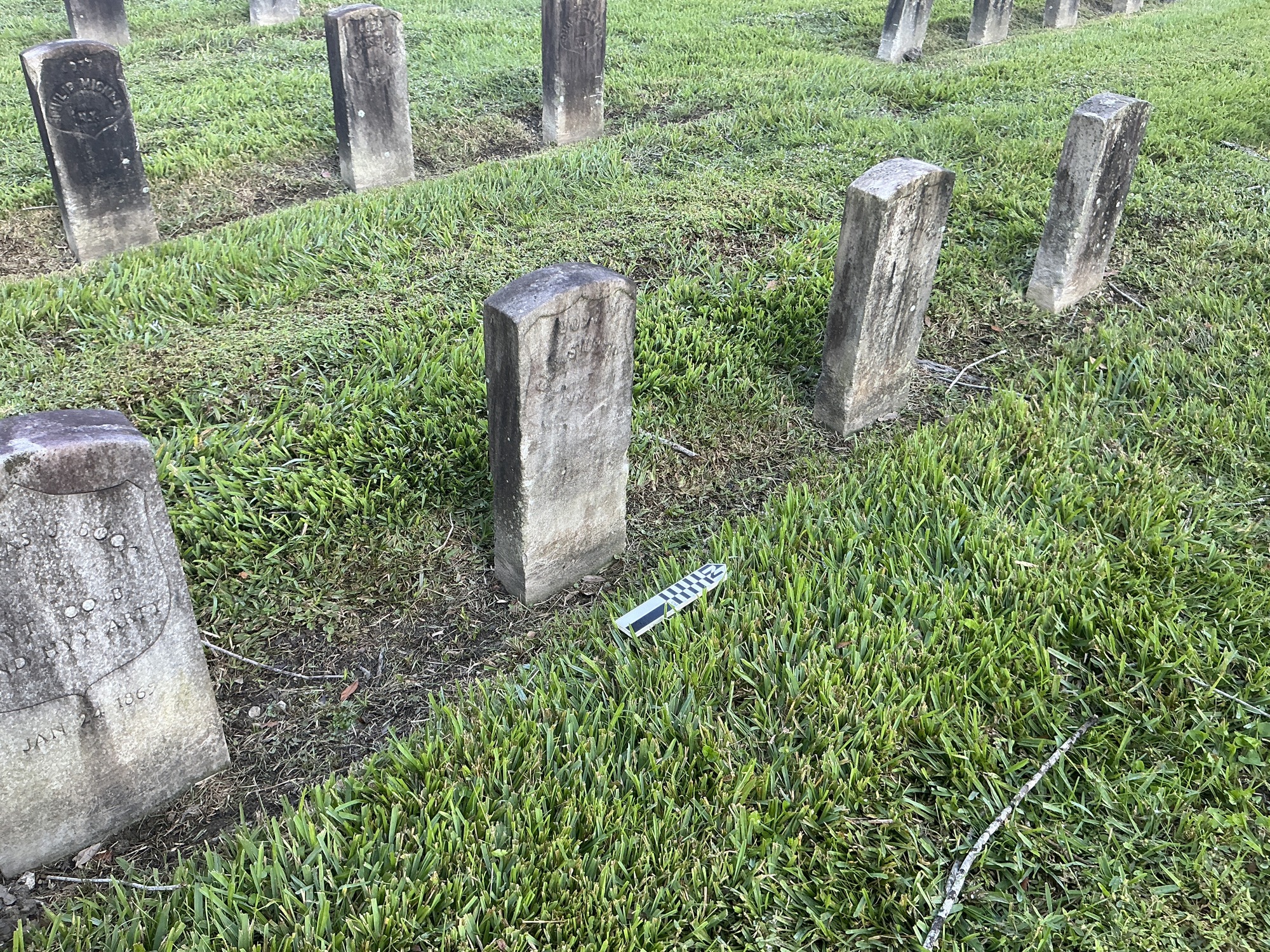 Extra image of historic upright marble headstone with recessed shield face.