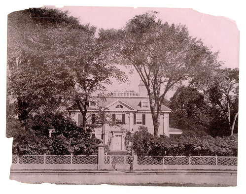 Georgian mansion from across the street framed by two tall trees