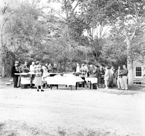 Men and women from the Fire Conference gathered outside for barbecue feast, April 1957. Near ranger dormitory.