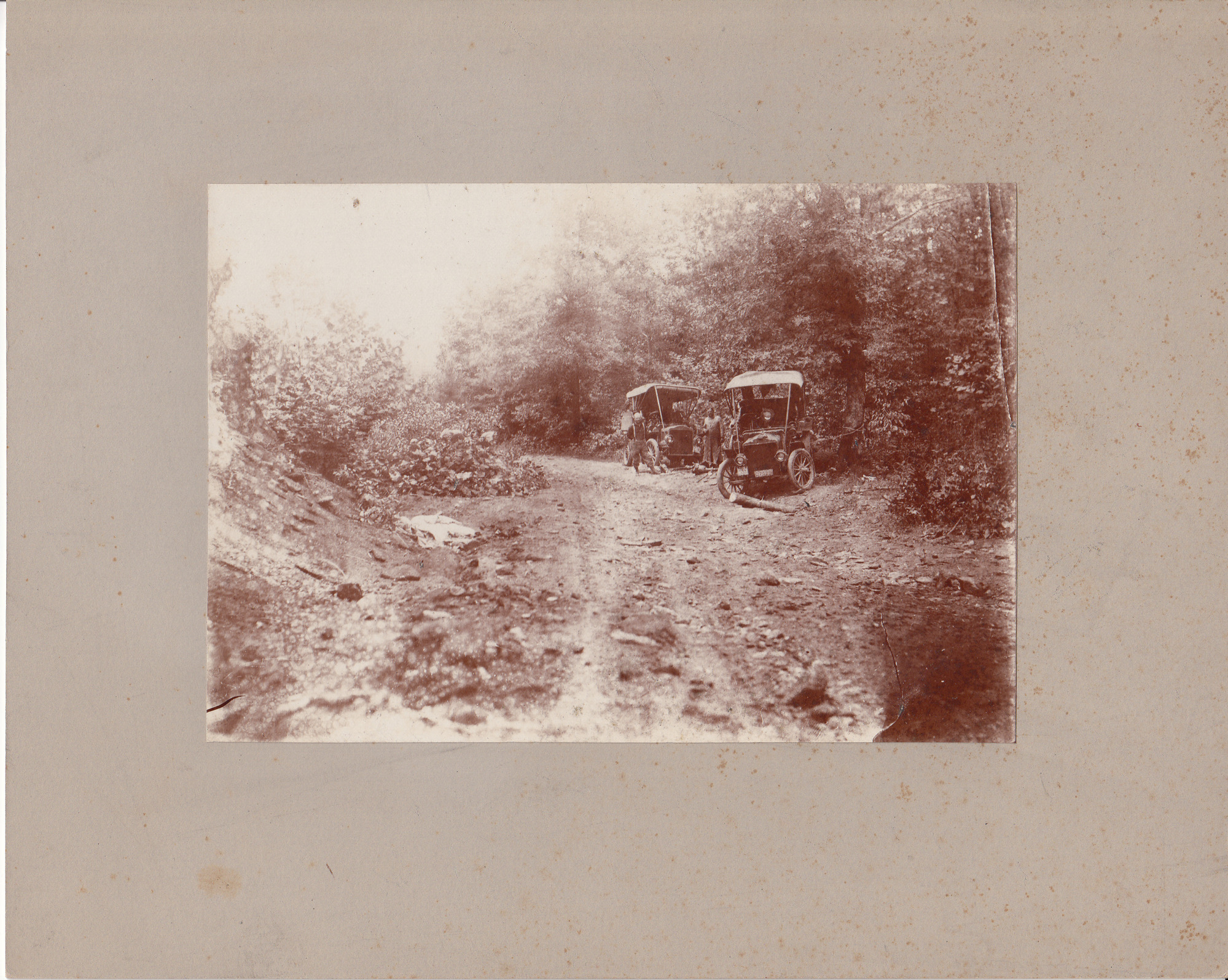 Thomas Edison asleep by the roadside during an automobile trip through North Carolina in search of cobalt, Fred Ott, right of automobile.