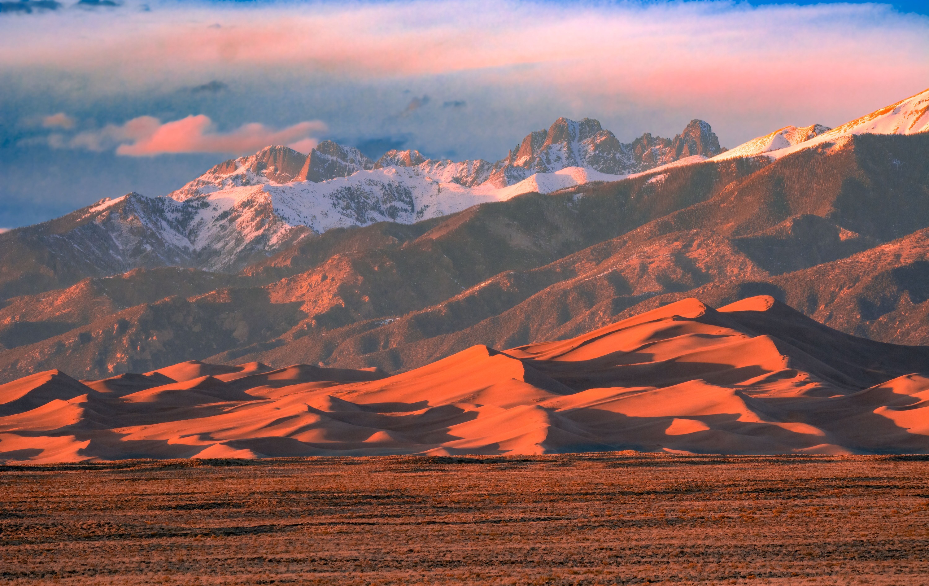Orange Sunset Light on Dunes and Snowy Crestone Peaks