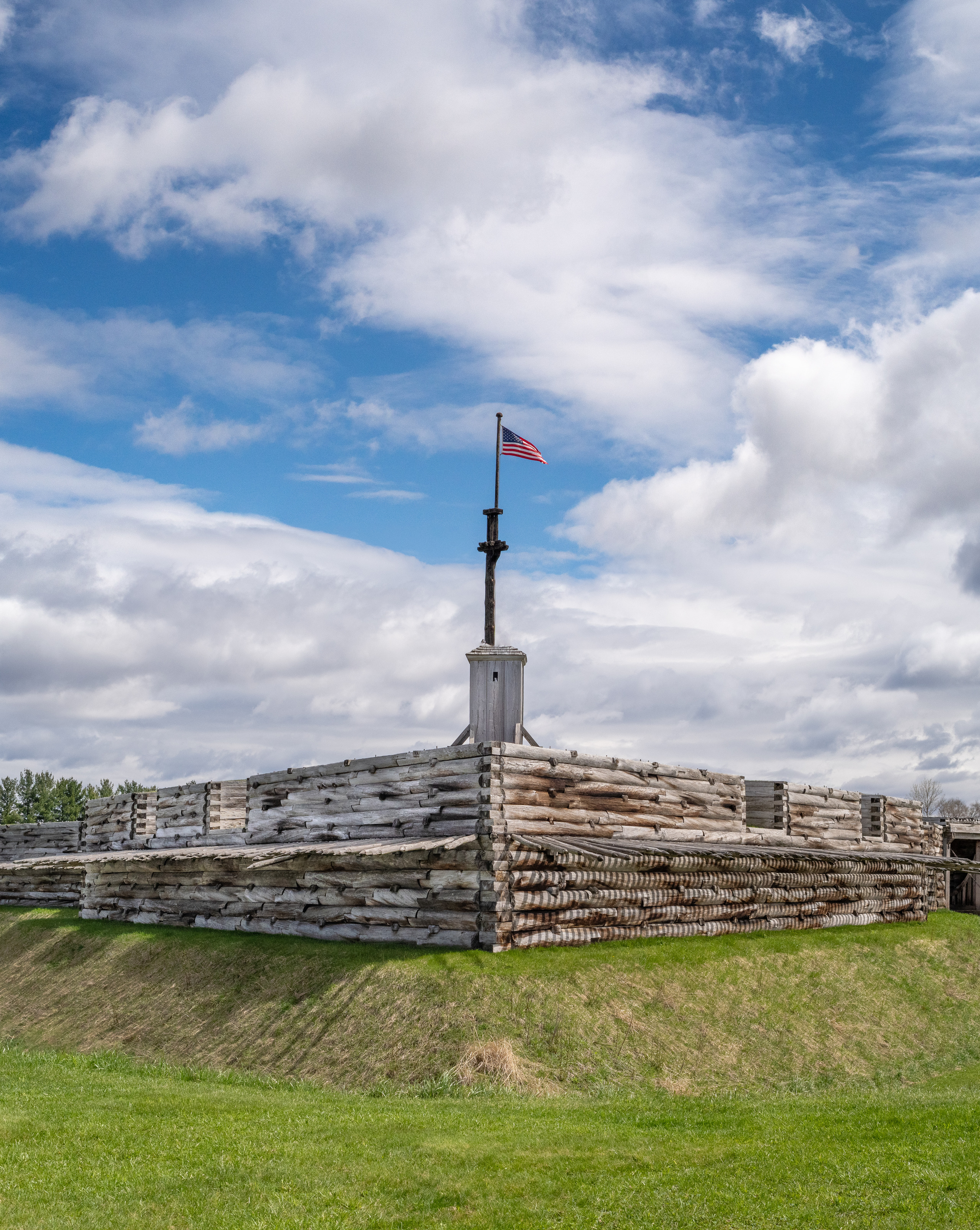 Rising in front of you is a large wooden wall with spikes coming out of the sides and a flag flies overhead. 
