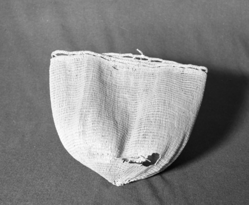 Marie Rozier Collection, Catalog No. 5-12-FM. Object: Aleut bag. Dimensions: 12" x 12". Materials: seagrass, Technology: diagonally twined, down to right slant of turns, braided bands at rim. Collection History: Gift of Flora Hill McCullough. Photographed by Michael Dixon, December 1982. Catalogued by Craig Bates and Barbara Beroza. Yosemite Collections, National Park Service.