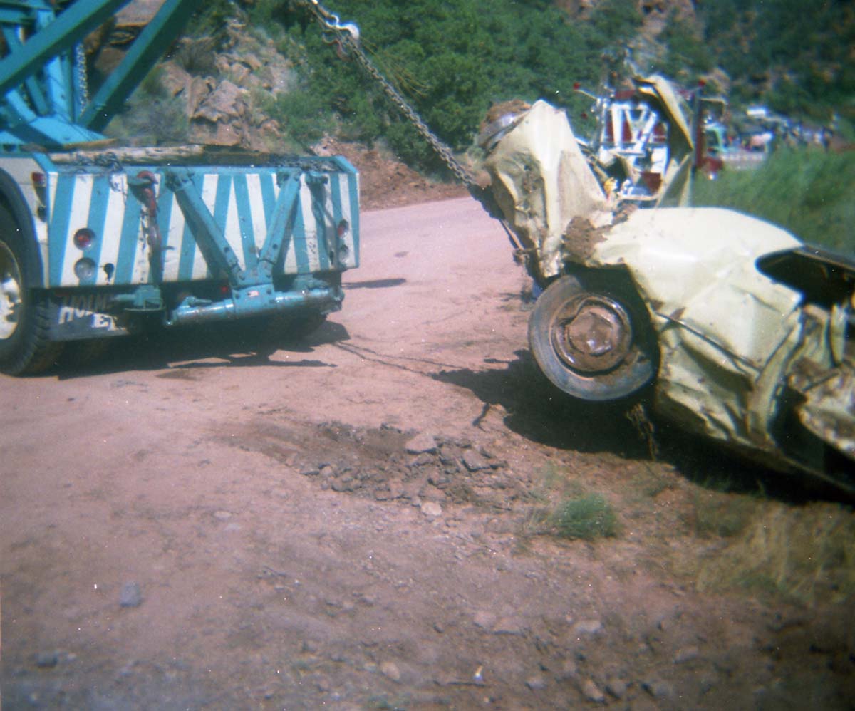 Color photos of park personnel removing a car from the flood waters of the 1975 flood.