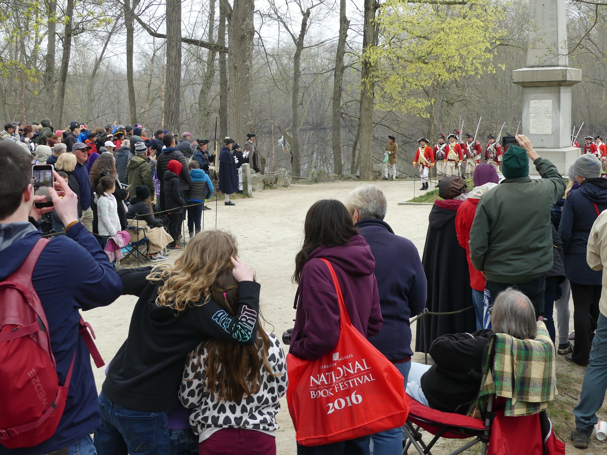 British troops marching past large crowd of spectators 