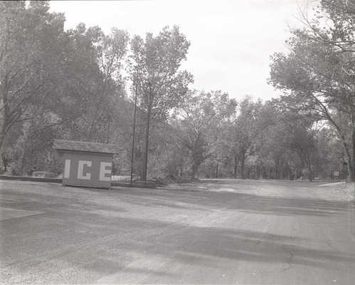Ice shed and parking area with surrounding trees in the South Campground.