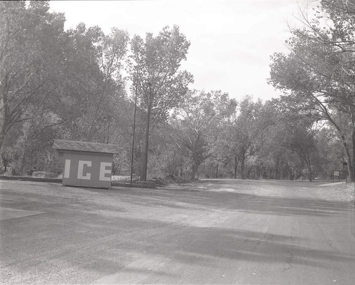 Ice shed and parking area with surrounding trees in the South Campground.