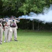 Confederate guards firing their muskets.