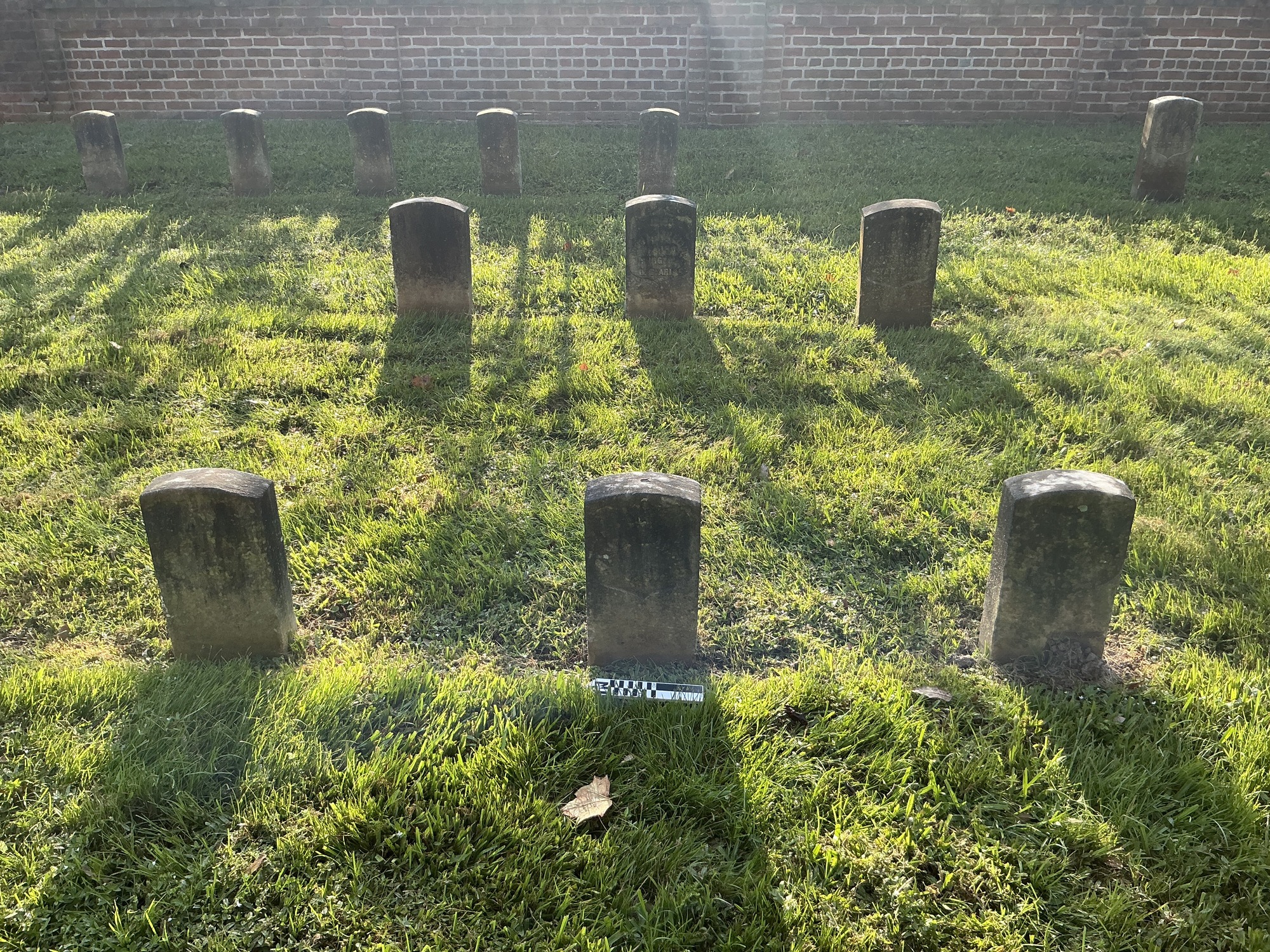 Extra image of historic upright marble headstone with recessed shield face.