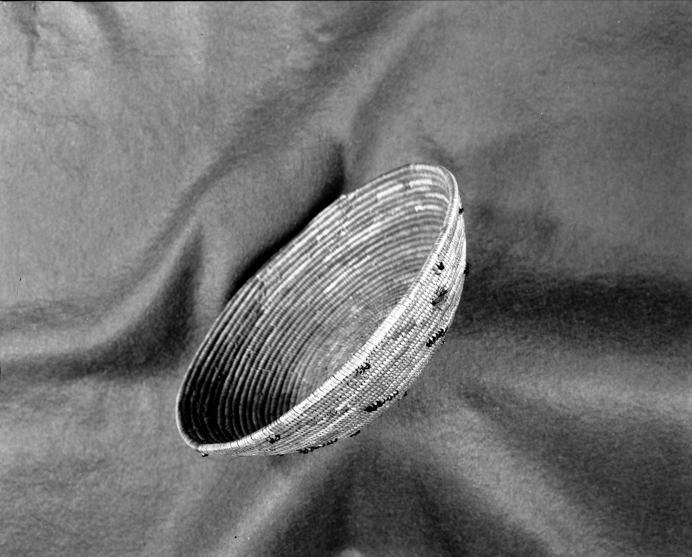 Salinan basket, probably by Perfecta Encinales Family. Grass bundle foundation, sedge root, glass beads. c. 1910-1920. Marion Steinbach Collection. Photographed June 1980 by Michael Dixon.