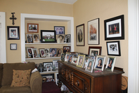 A small living room with a large collection of frame photographs.