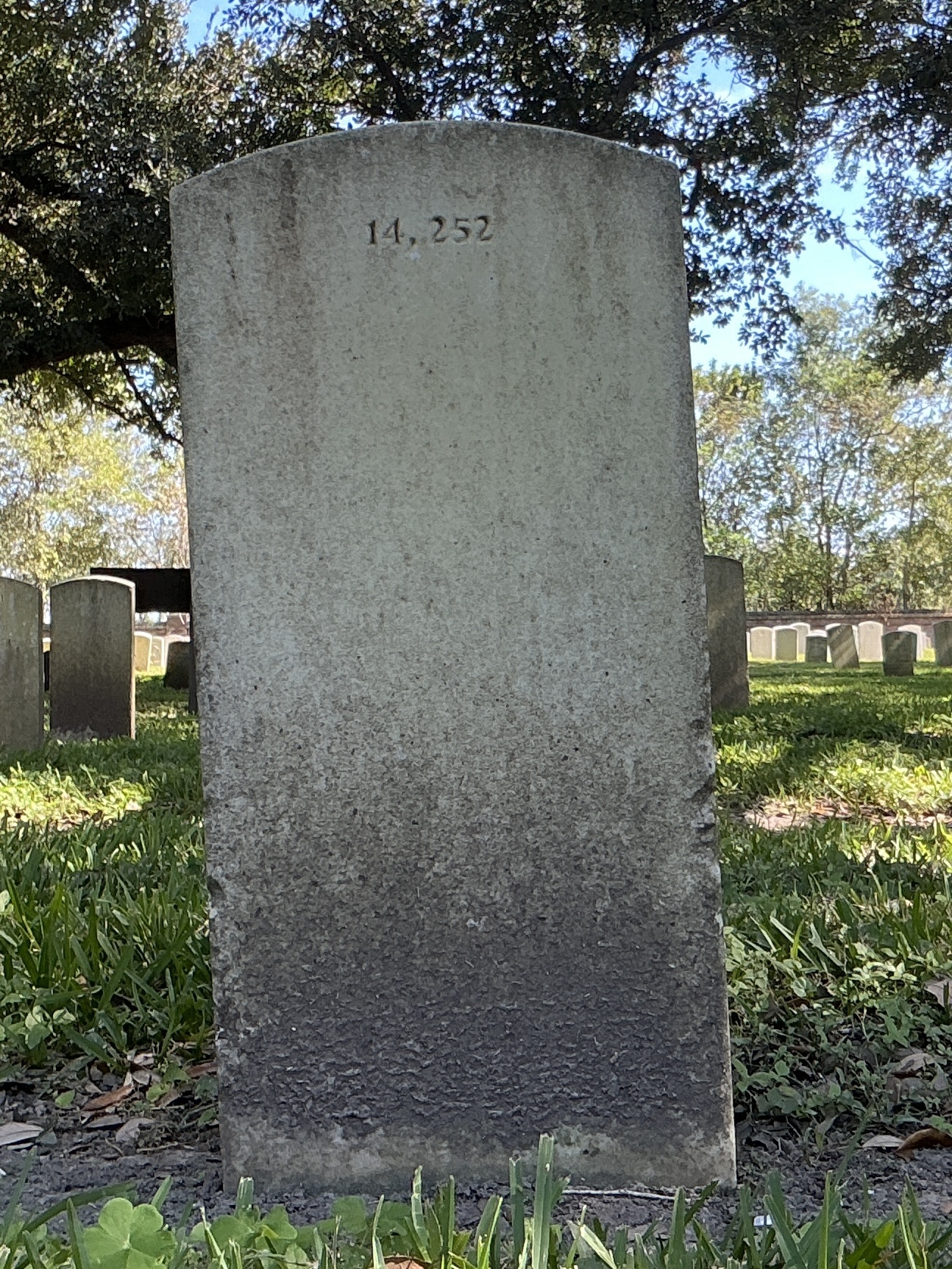 Back of upright marble headstone with flat face.
