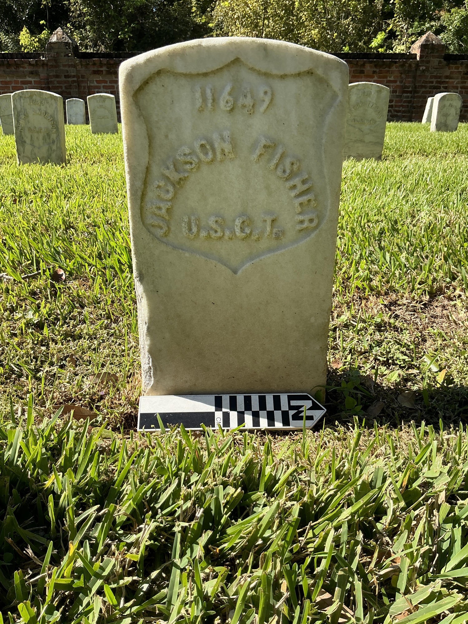 Extra image of historic upright marble headstone with recessed shield face.