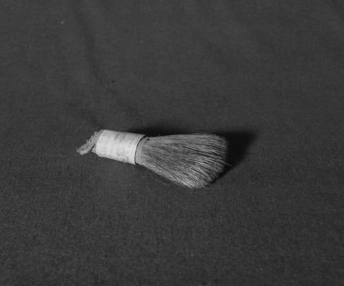 Marie Rozier Collection, Catalog No. 27. Object: Miwok soaproot brush. Dimensions: 7". Materials: soaproot fiber, cotton cloth, cotton string. Collection History: Made and used by Mrs. Louise Fuentes, to clean up around stove and kitchen. Purchased from her in early 1950s. Photographed by Michael Dixon in December 1982. Catalogued by Craig Bates and Barbara Beroza. Yosemite Collections, National Park Service.