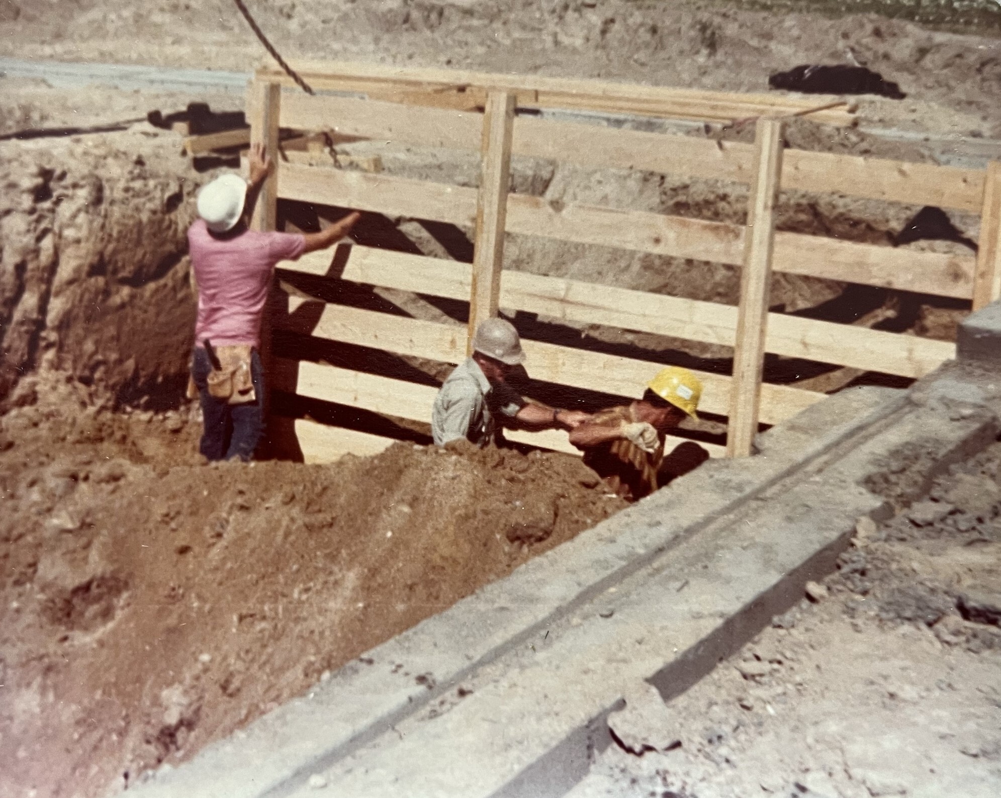 Construction workers place temporary shoring in the well room for the well pit. 