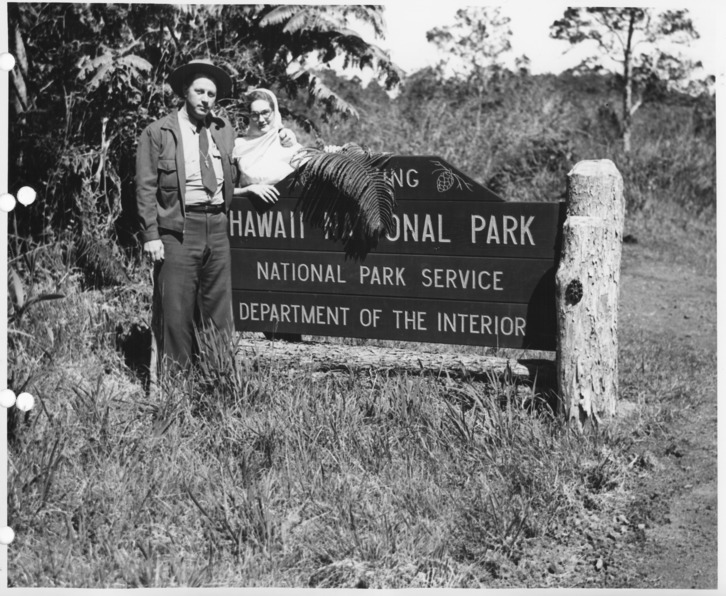 Black and white photo of a couple standing by the entrance sign to Hawaii National Park, National Park Service, Dept. of the Interior