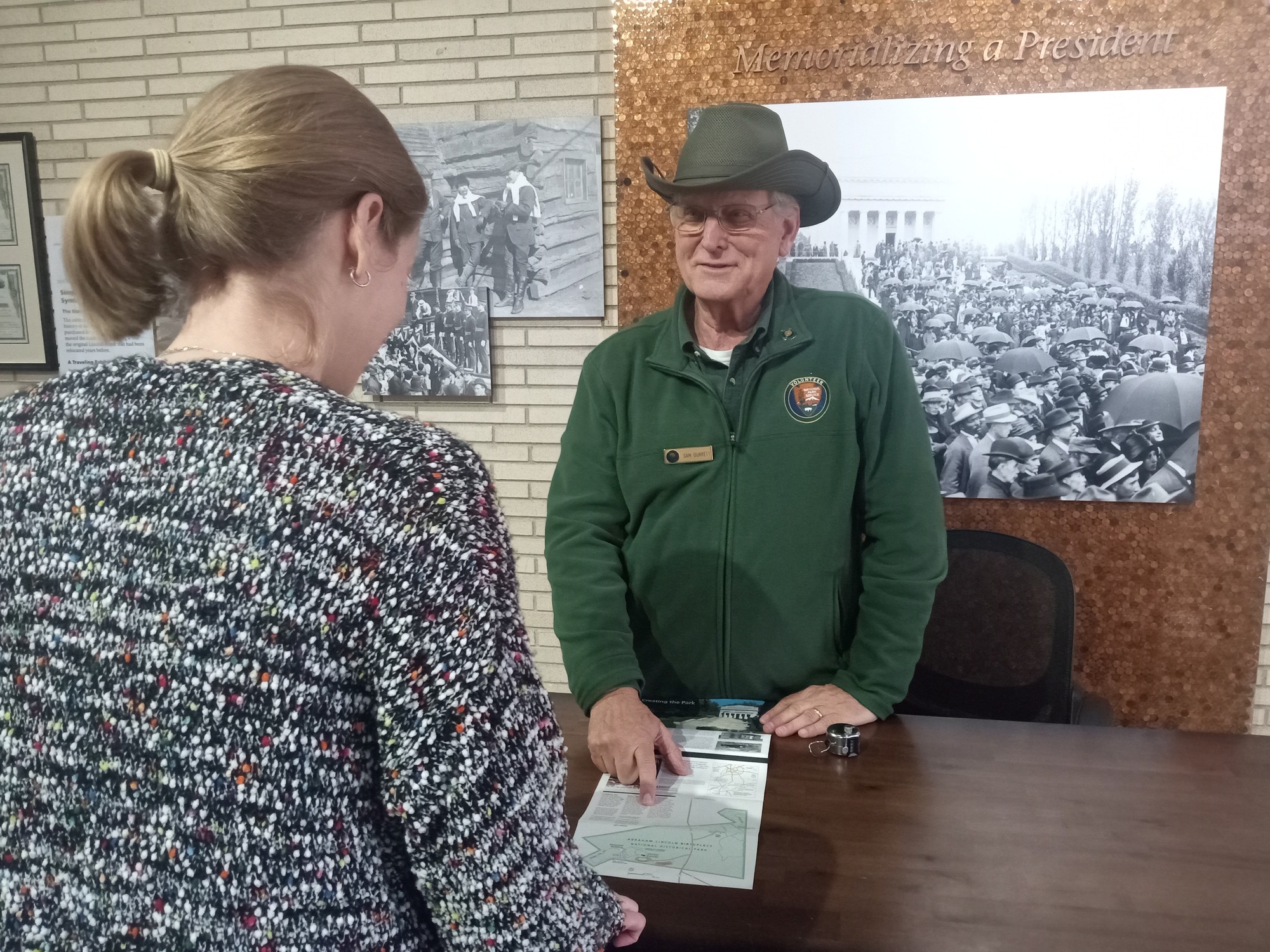 Volunteer giving directions to visitor