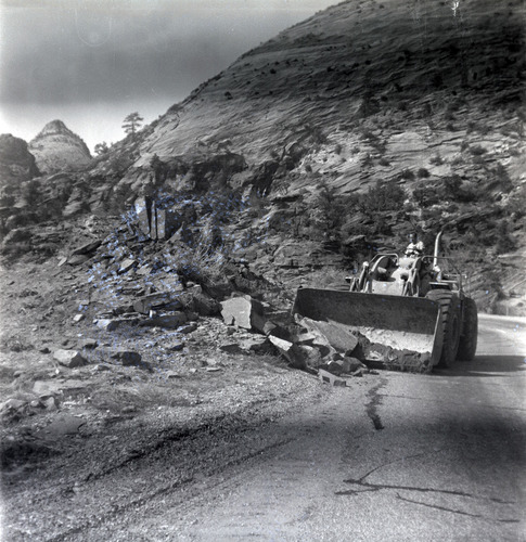 Construction vehicle clearing rocks during east side road repair and turn out construction.