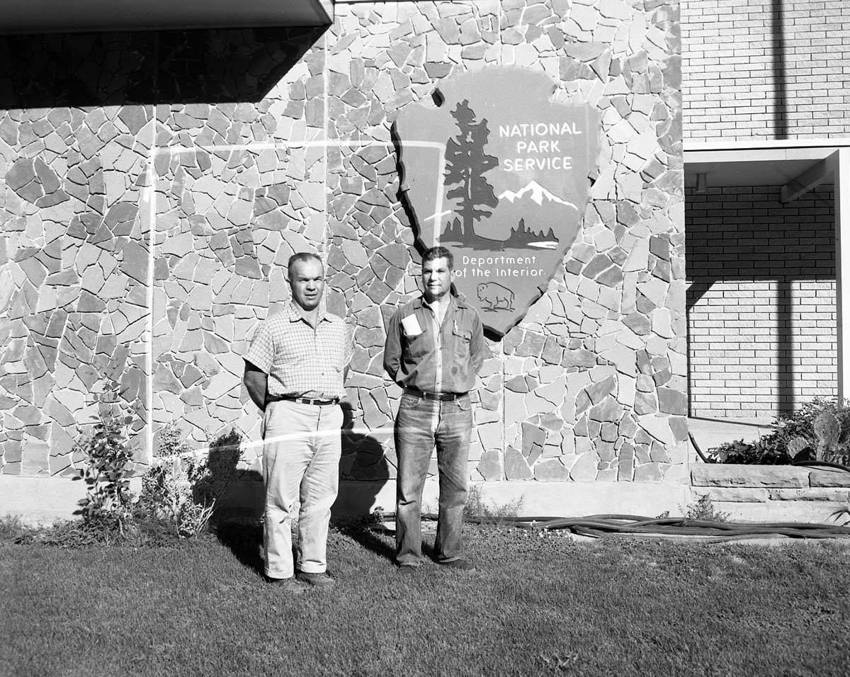 Award recipients standing in front of Mission 66 Visitor Center and Museum: Emil Justet awarded $300 for extraordinary performance of duty, and Wesley Dennett awarded for completion of 20 years of service.