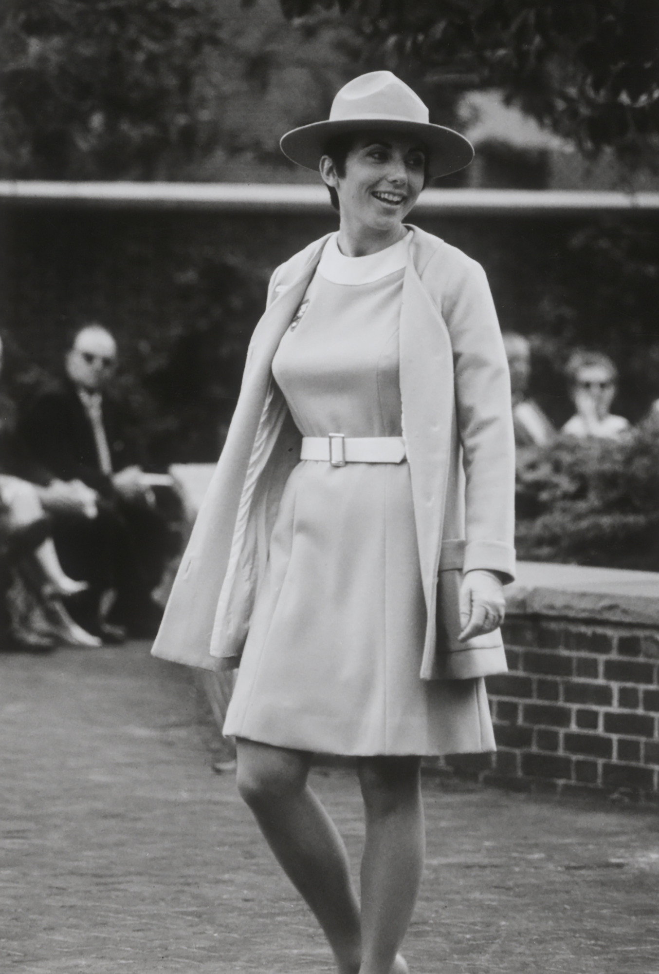 Carole Scanlon modeling the 1970 belted dress and matching jacket with the women's broad-brimmed hat.
