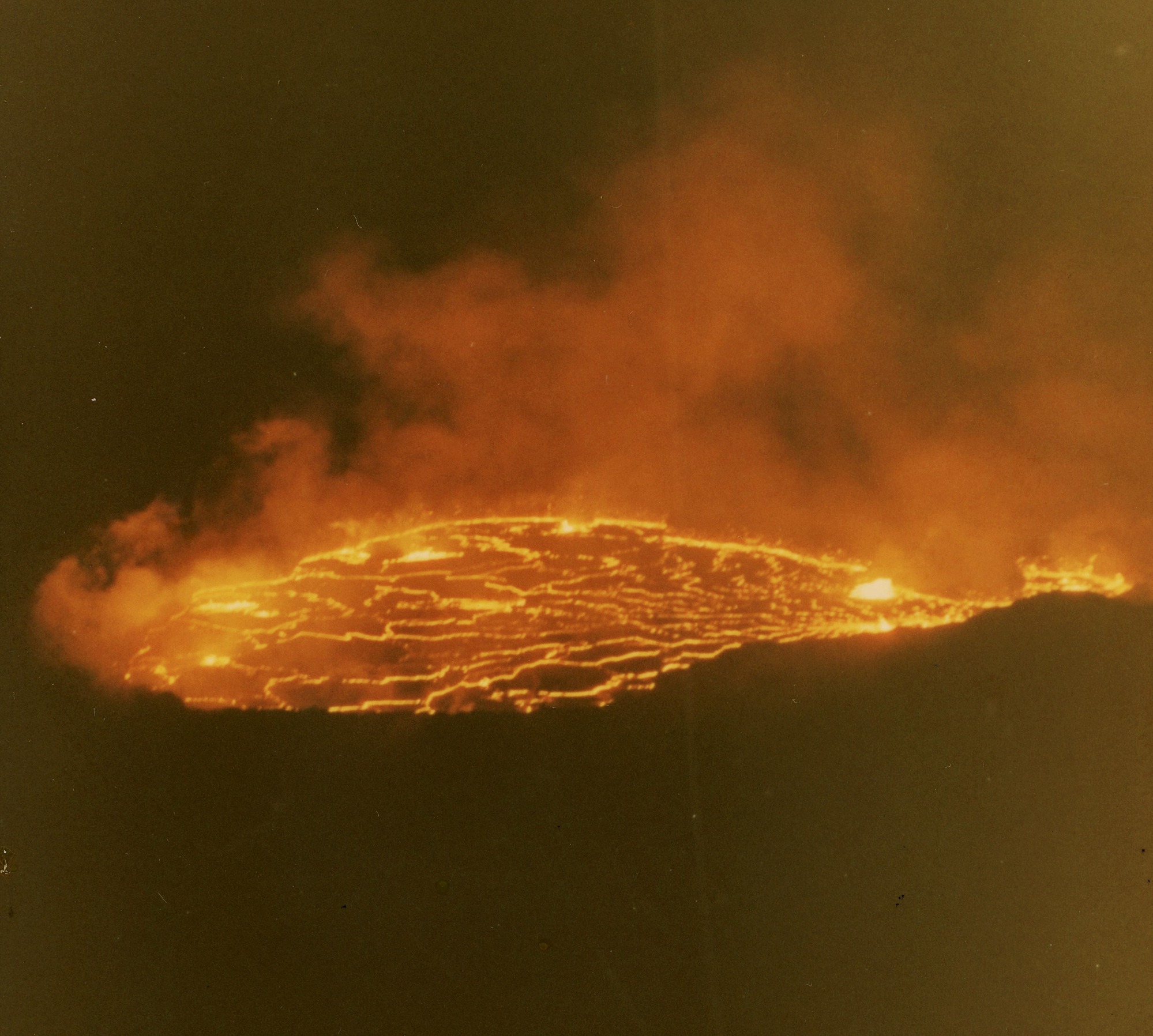 Molten lava flow at night from above