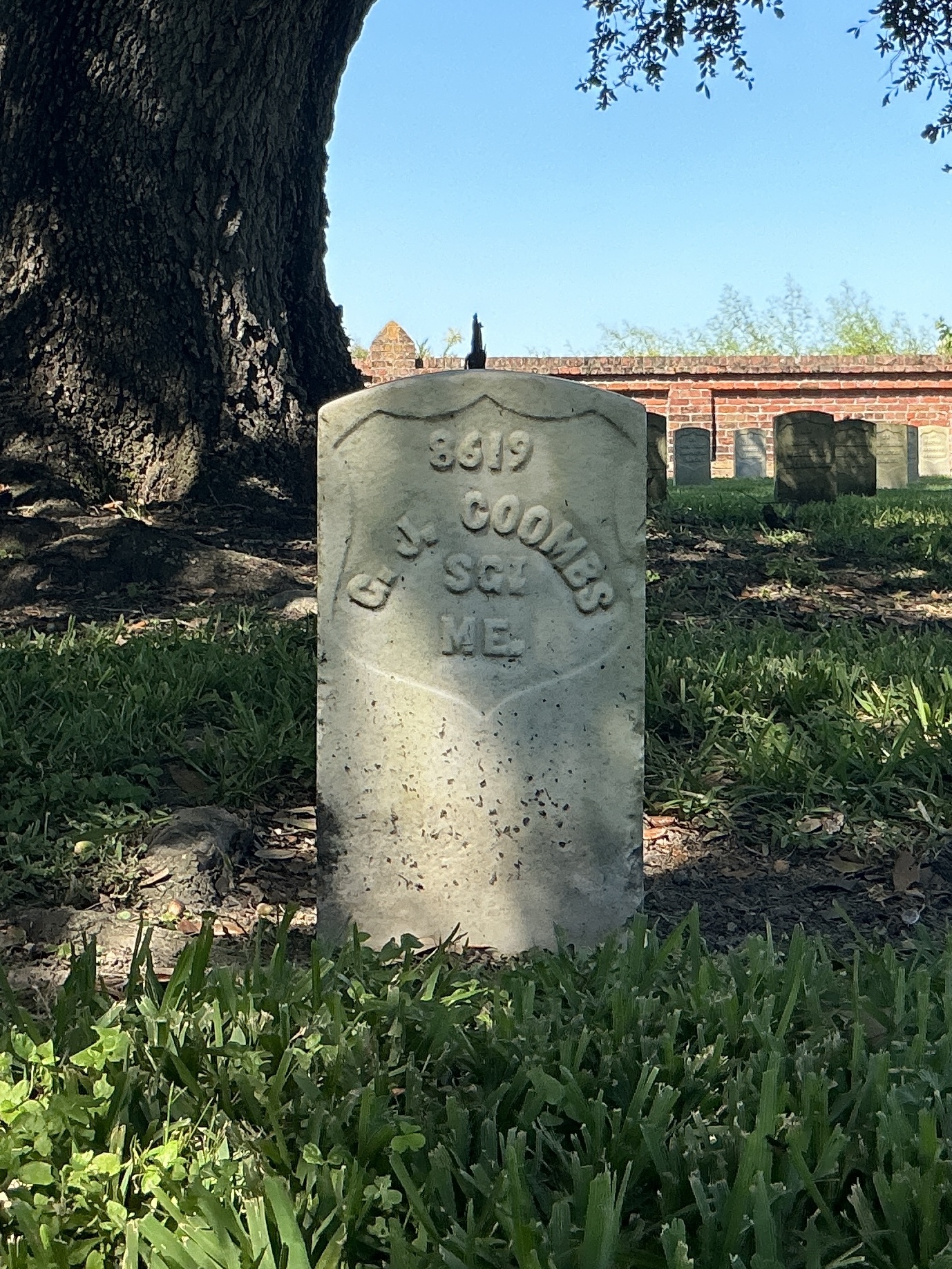 Front of historic upright marble headstone with recessed shield face.