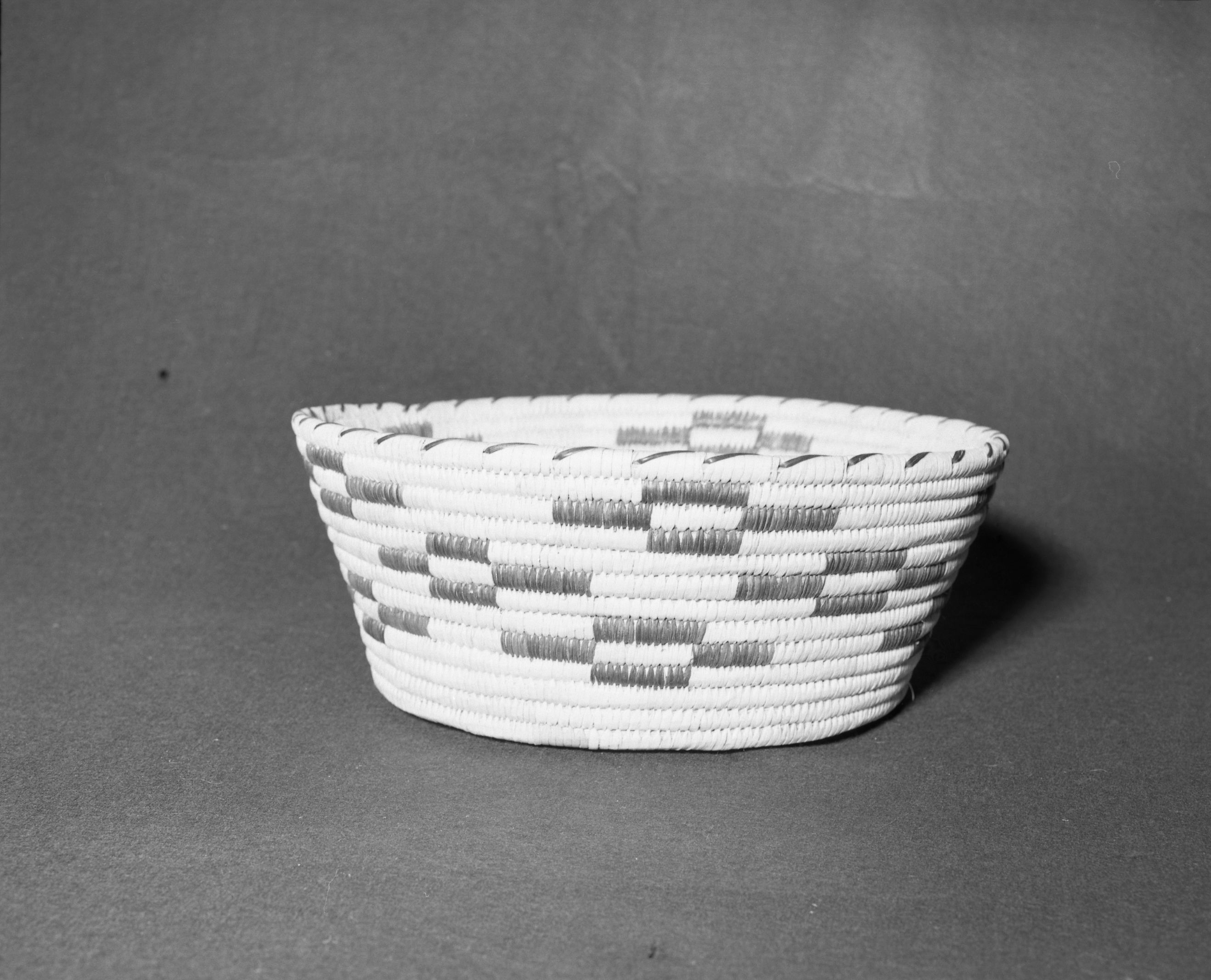 Mrs. Donald Segerstrom Collection. Object: Papago basket. Dimensions: 15 x 5 1/2". Materials: yucca, devil's claw. Technology: ---. Collection History: ---. Photographed by Michael Dixon, 1/83. Catalogued by Craig Bates and Barbara Beroza. Yosemite Collections, National Park Service.