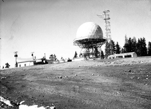 The radar station on Blowhard Mountain, near Cedar Breaks National Monument. Snow track vehicle parked in front.