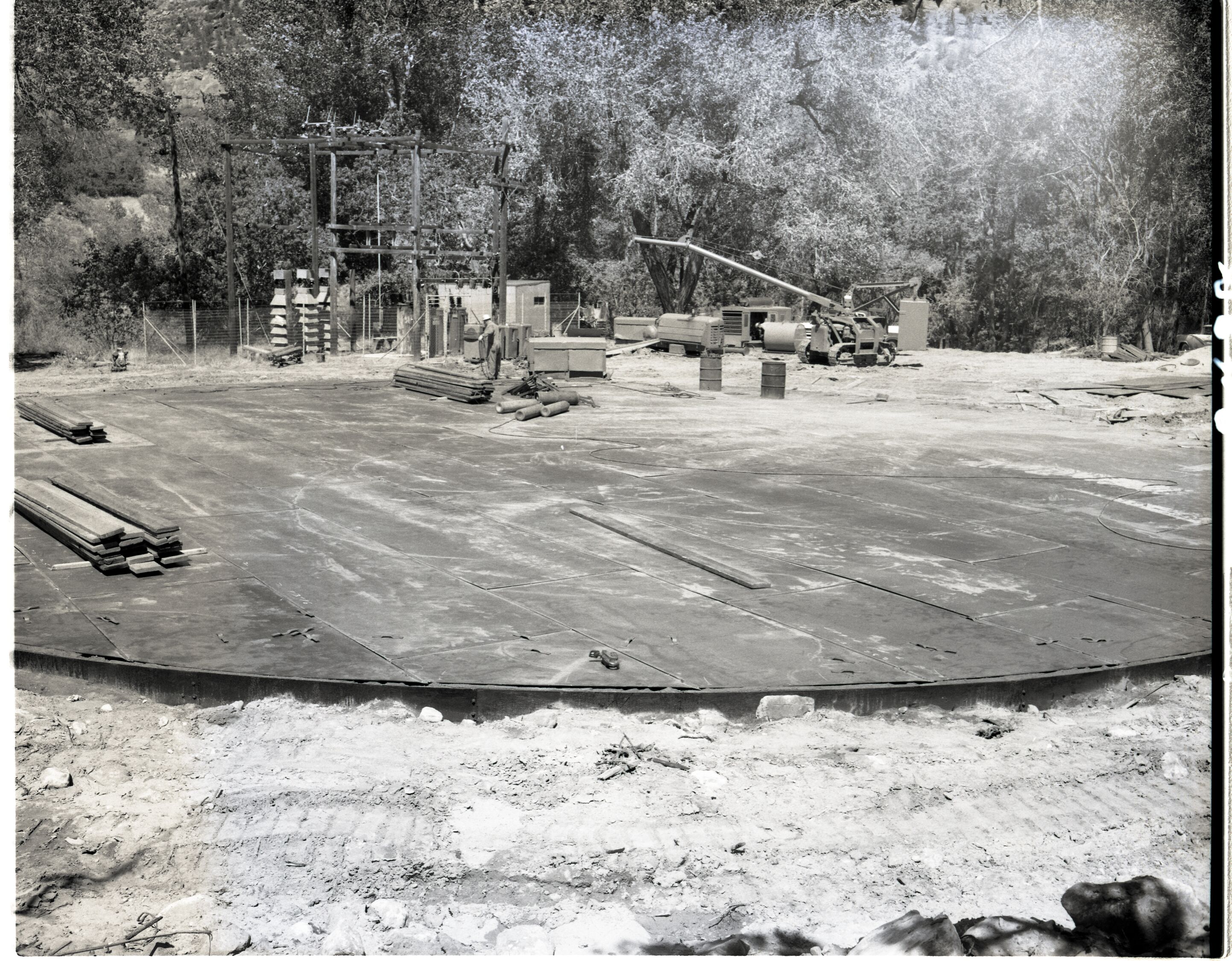 Construction of million gallon water tank at Birch Creek - laying steel plate for floor.