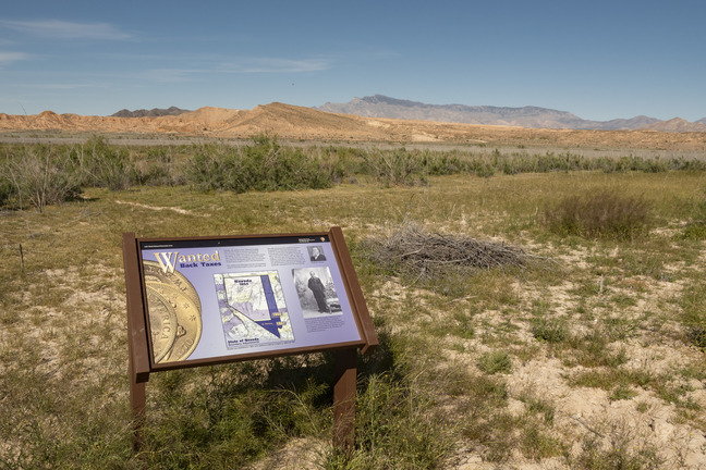 educational sign, mountains in the distance