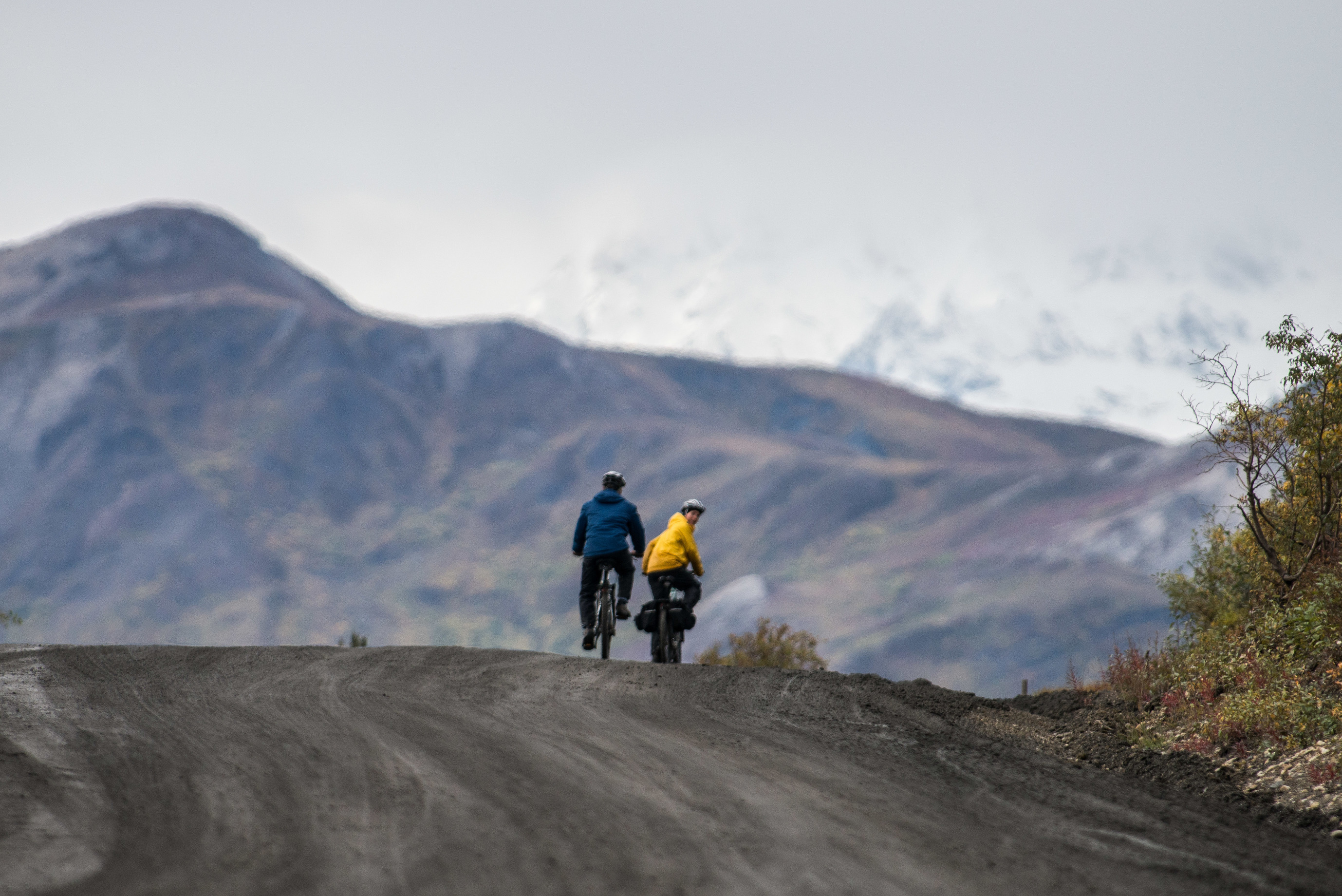 two people biking a gravel road