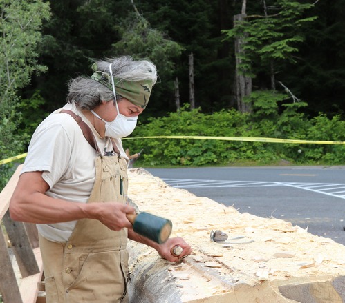 Tommy Joseph uses a chisel and mallet to remove more the the excess wood, and begins to hollow out the log.